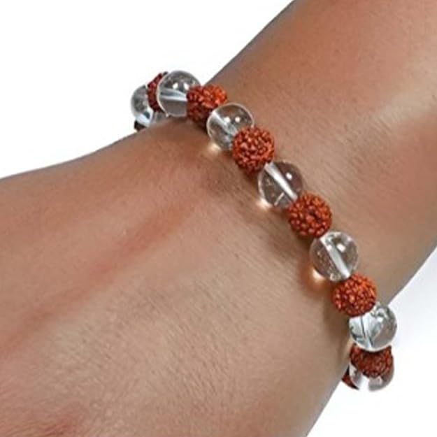 A close-up of a wrist wearing an Arihant Gems & Jewels Diamond-Cut Rudraksha & Sphatik Bracelet, featuring alternating clear and brown natural, certified astrological beads for men and women (unisex).