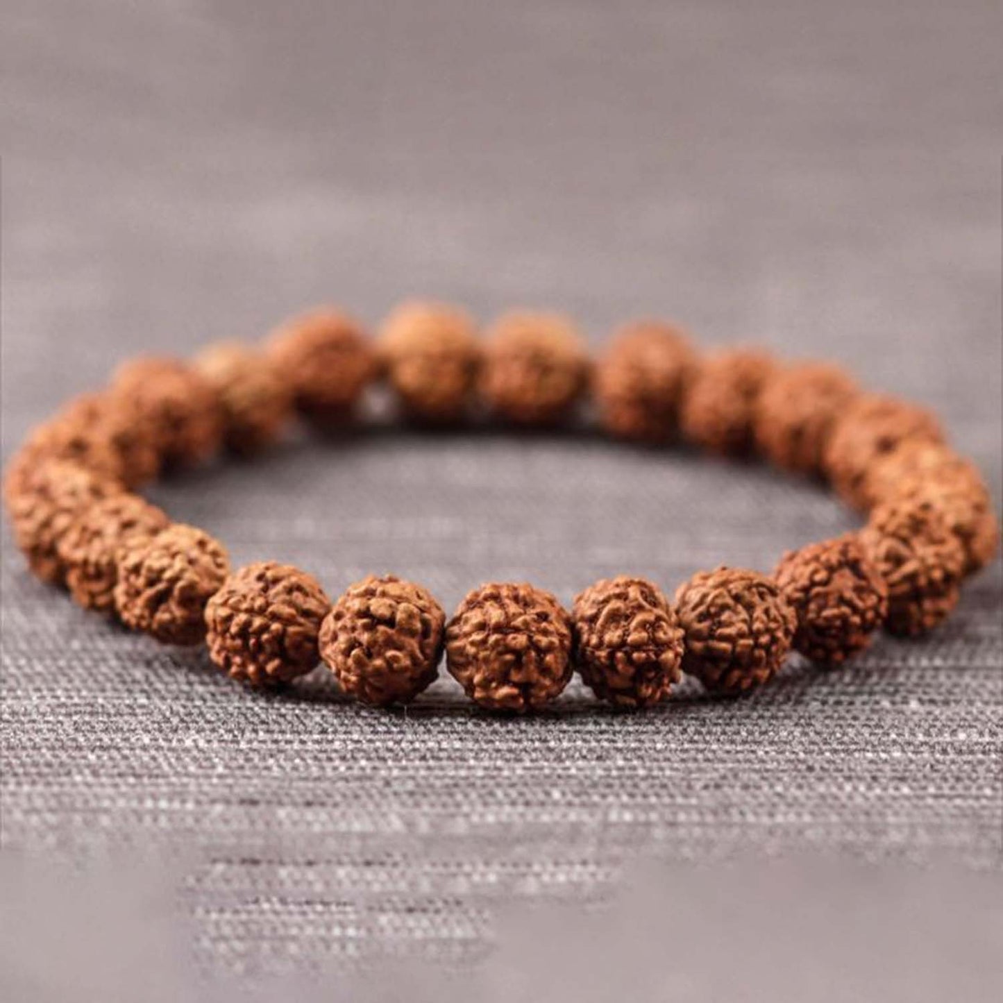 Rudraksha bracelet made of natural brown prayer beads on white background
