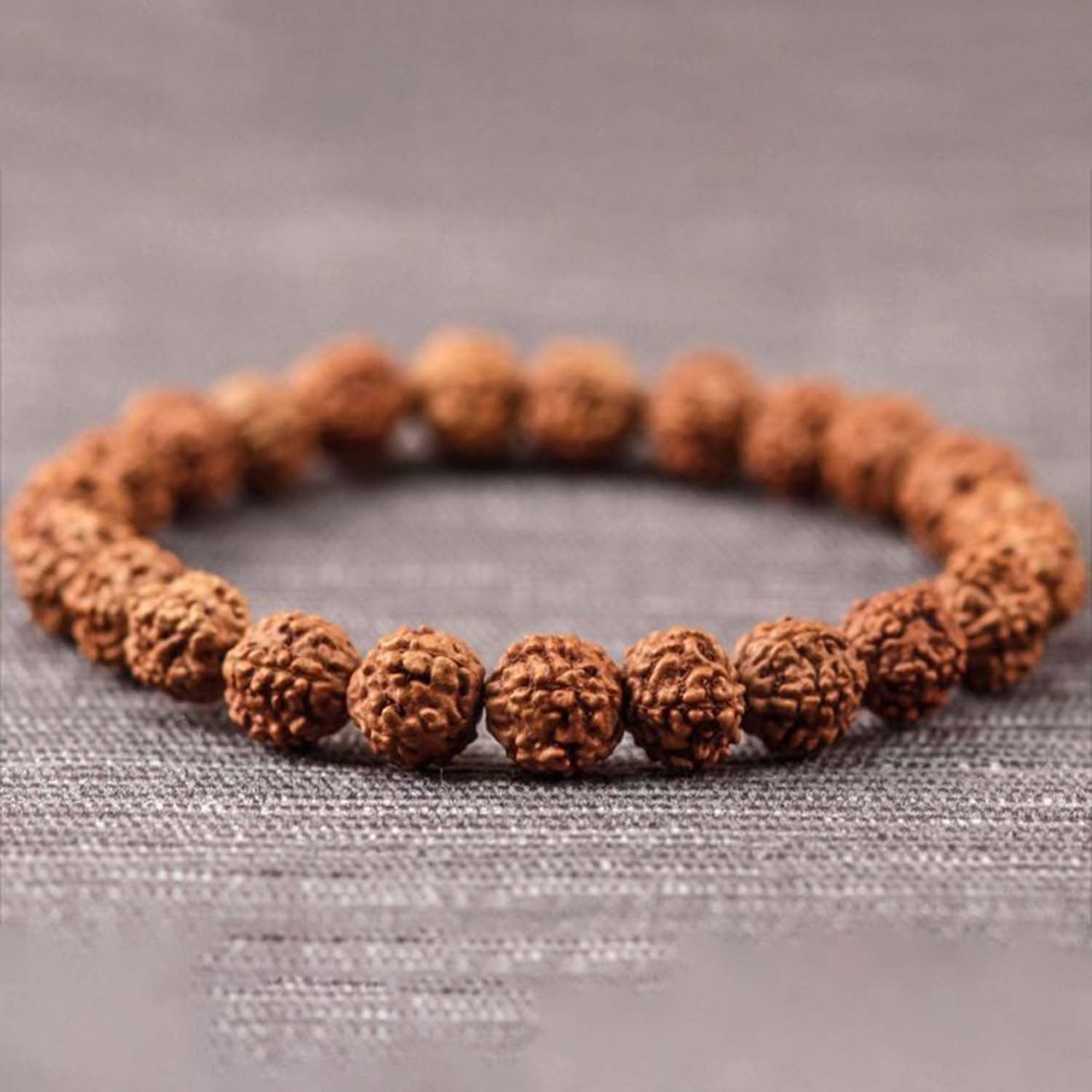 Rudraksha bracelet made of natural brown prayer beads on white background