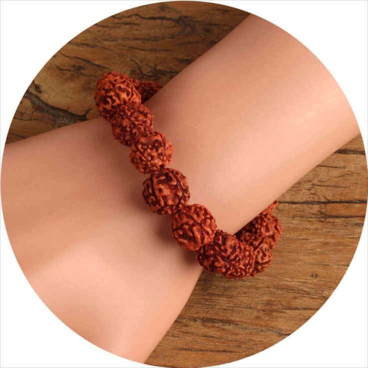 Man wearing a Rudraksha bracelet on wrist – natural wooden beads close-up