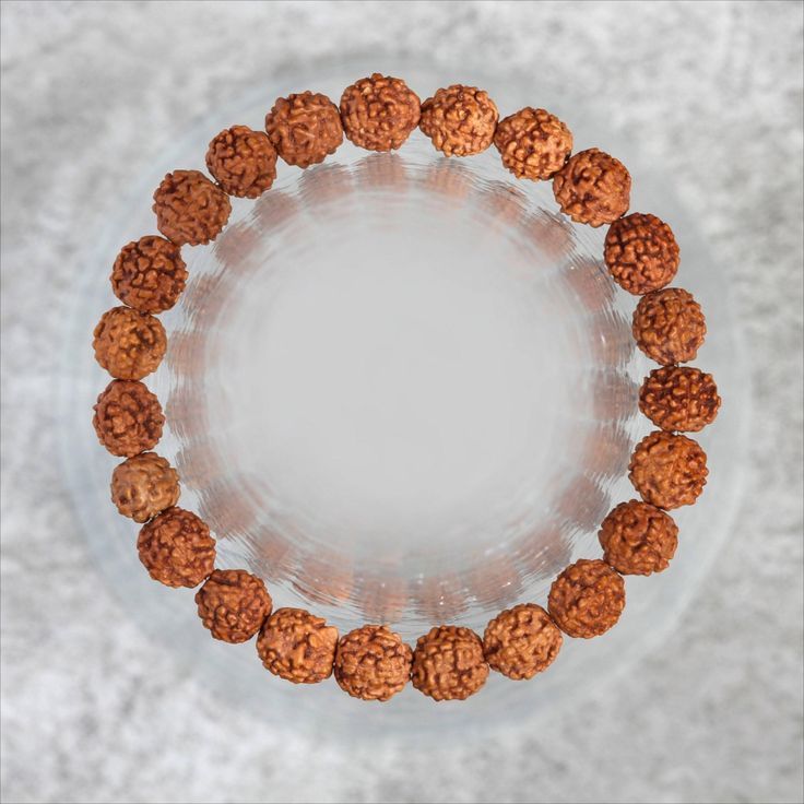 Rudraksha bracelet made of natural brown prayer beads on white background